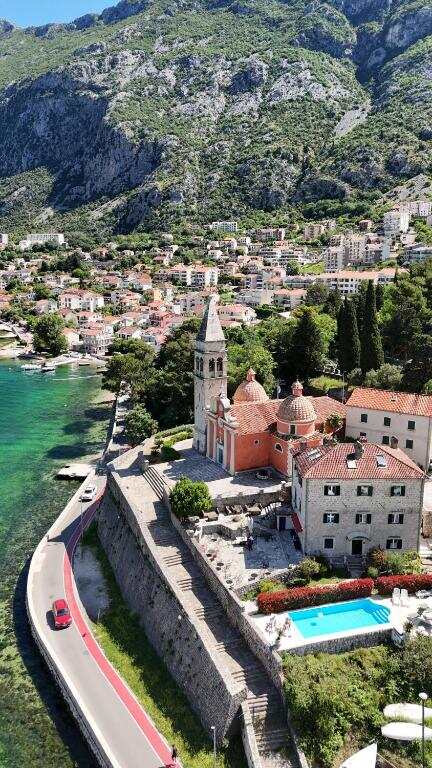 Aerial view of Villa Kamena, the church and the waterfront road in Dobrota